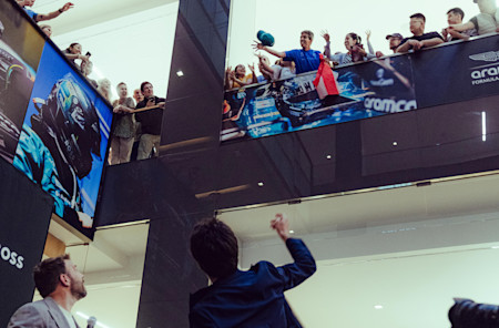 Some of the crowd pick up a special memento of the day as Lance throws signed caps to them